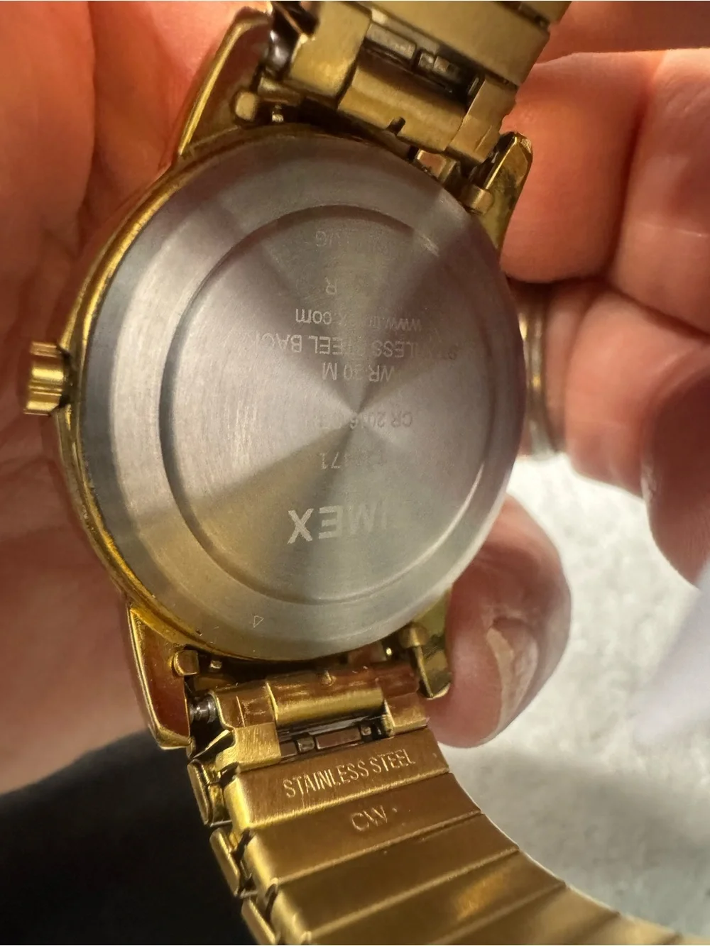 Timex Gold Tone Watch with White Dial and Black Numerals
